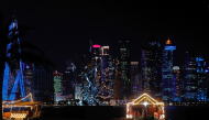 The Corniche promenade facing the skyline of illuminated high-rise buildings is pictured in Doha on October 11, 2026. (Photo by KARIM JAAFAR / AFP)
