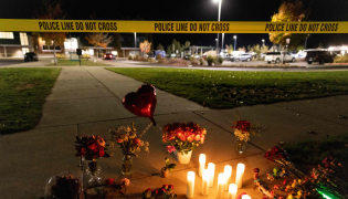 Candles and flowers are seen at a makeshift memorial outside the Silver Rail Elementary School following a shooting in Bend, Oregon, on October 15, 2026. Photo by Payton Bruni / AFP