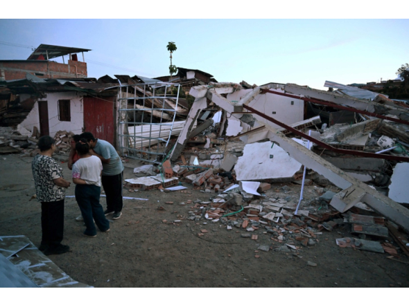 People gather in front of a house damaged by an earthquake in Colombia. AFP file photo.