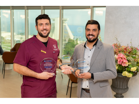 Dr. Yaser Hamdoun (left) receiving the awards. 