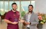 Dr. Yaser Hamdoun (left) receiving the awards. 