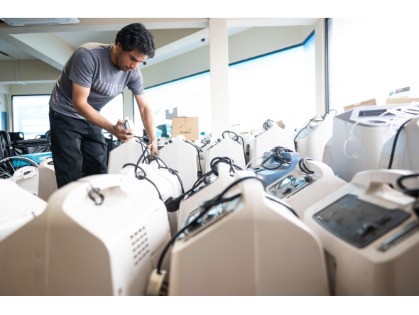 A technician inspects oxygen concentrators awaiting repair and cleaning at a medical supply warehouse in Kuala Lumpur on October 15, 2026. (Photo by Mohd Rasfan / AFP) 