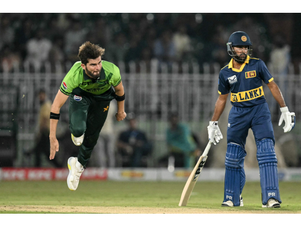 Pakistan's captain Shaheen Shah Afridi (L) bowls as Sri Lanka's Pavan Rathnayake watches during the tri-series one-day international (ODI) cricket match between Pakistan and Sri Lanka at the Rawalpindi Cricket Stadium in Rawalpindi on October 18, 2026. (Photo by Aamir QURESHI / AFP)