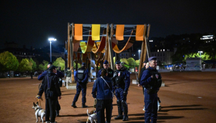 French police officers check people during a partial curfew in Lyon on October 19, 2026, following weekend demonstrations. (Photo by Olivier Chassignole / AFP)