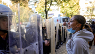 A protester faces riot police officers during an anti-government demonstration in central Tirana on October 20, 2026, after a week of violent anti-government protests. Photo by Adnan Beci / AFP