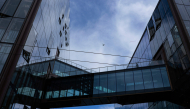 An airplane flies over Open AI headquarters as seen on October 20, 2026 in San Francisco, California. Heather Diehl/Getty Images/AFP