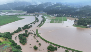 In this file photo July 25, 2024 and released courtesy of the Akita Prefecture River Sabo Division to AFP on July 26, shows flooding along the Ishizawa river, whose embankment collapsed due to heavy rains, in Yurihonjo, Akita prefecture. Photo by Handout / Akita Prefecture River Sabo Division / AFP   