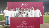 The connections of Weissmuller pose with the Sealine Cup, presented by Deputy Director of the QREC Registration and Studbook Department Saad Ali Al Kubaisi. BELOW: Szczepan Mazur steers Weissmuller to victory in the Sealine Cup. PICS: Juhaim/QREC