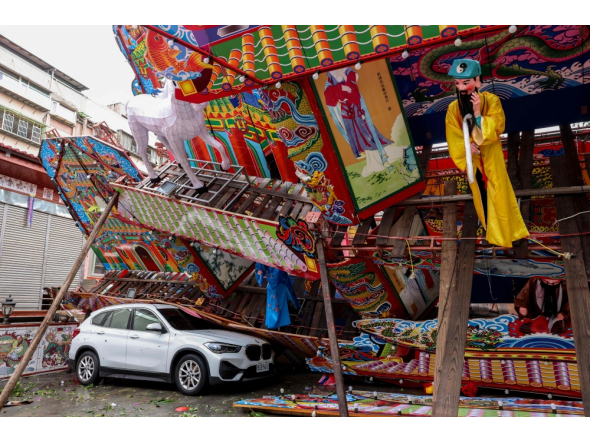 A temporary structure built for a traditional Taoist religious ceremony lies collapsed due to strong winds from Typhoon Champi in Keelung on October 24, 2026. (Photo by I-Hwa Cheng / AFP)
