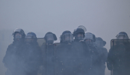 French gendarmes stand amidst tear gas during a demonstration in favor of purchasing power, the protection of public services, and fiscal and social justice, in Nantes, western France on October 24, 2026 (Photo by Guillaume Saligot / AFP)