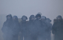 French gendarmes stand amidst tear gas during a demonstration in favor of purchasing power, the protection of public services, and fiscal and social justice, in Nantes, western France on October 24, 2026 (Photo by Guillaume Saligot / AFP)
