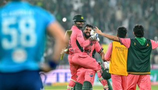 Pakistan's Shadab Khan (2L) and Haris Rauf (L) celebrate after their team's victory in the one-day international (ODI) tri-series cricket match against England at the Gaddafi Stadium in Lahore on October 25, 2026. (Photo by ARIF ALI / AFP)