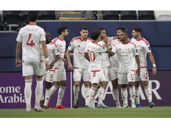 Al Shamal players celebrate a goal against Al Hilal.