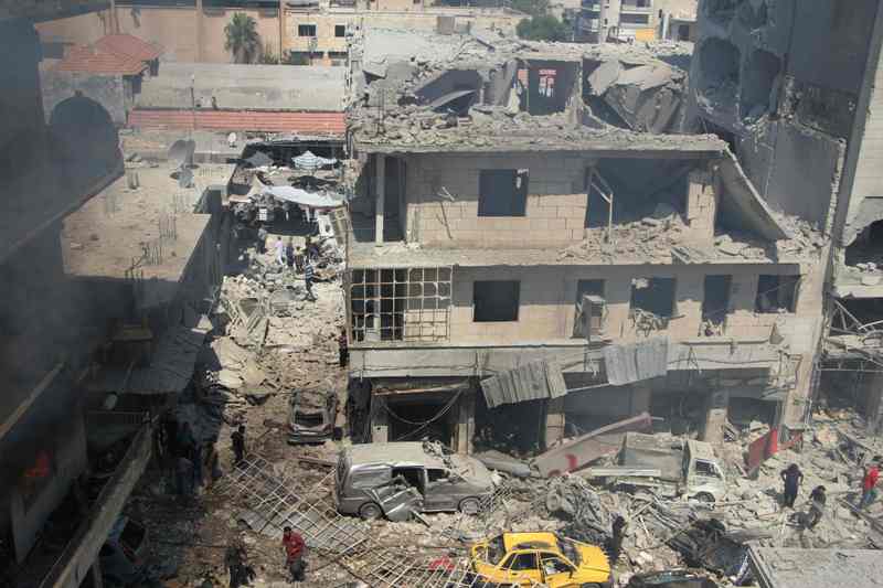 Syrians search for victims at the scene of a reported air strike on the rebel-held northwestern city of Idlib on September 10, 2016. More than 290,000 people have been killed in Syria since its conflict erupted in March 2011, and millions displaced by the