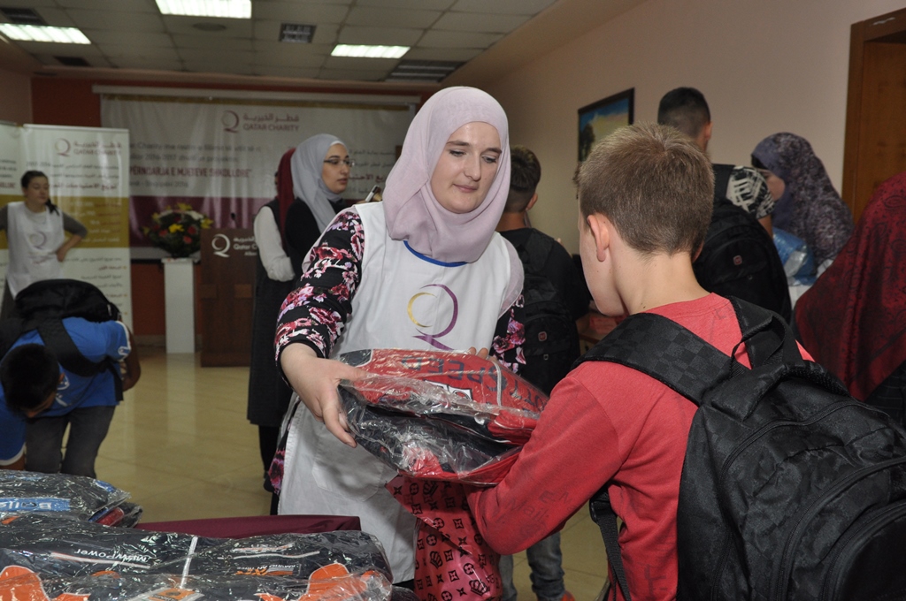 A student receiving school supplies at a Qatar Charity distribution centre in Tirana.