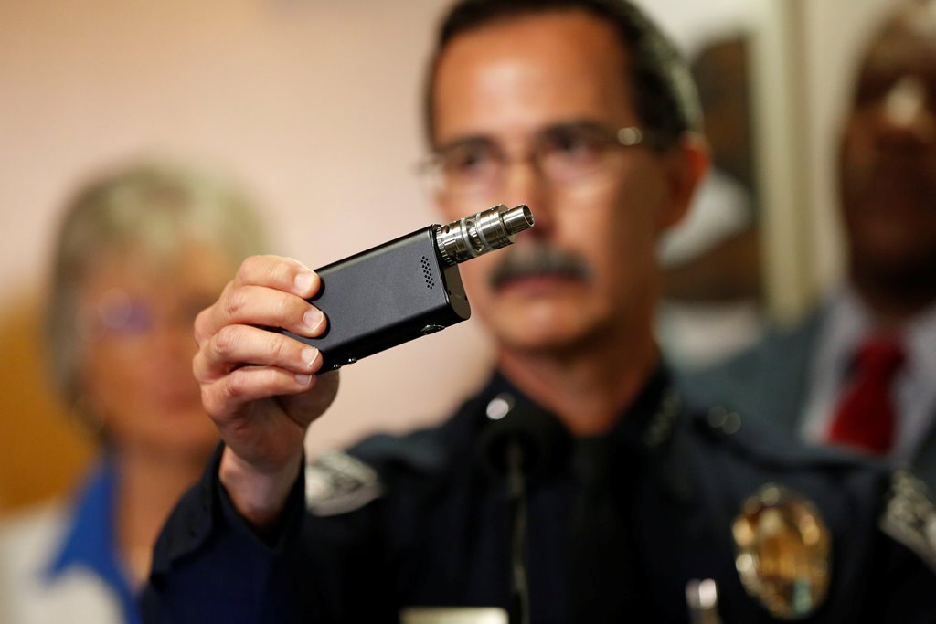 Police Chief Jeff Davis holds up a vape similar to the one held by Alfred Olango after police released video showing the the death of Alfred Olango, who was shot by El Cajon police Tuesday, at the El Cajon Police Department headquarters in El Cajon, Calif