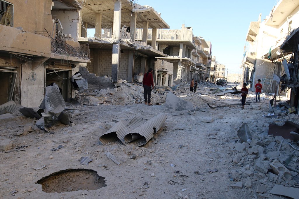People inspect a damaged site after airstrikes on the rebel held Sheikh Fares neighbourhood of Aleppo, Syria October 1, 2016. (Abdalrhman Ismail/Reuters)