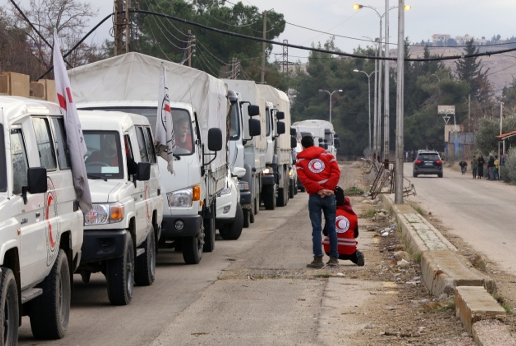 A Red Cross aid convoy waits on the outskirts of Madaya on Monday. (Louai Beshara/AFP/Getty Images)