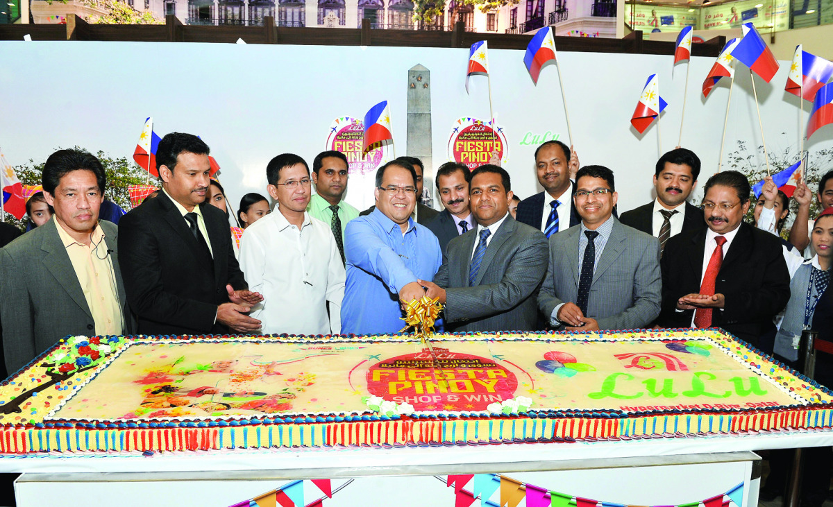 Philippine Ambassador to Qatar Wilfredo C Santos (fourth left) cuts a ceremonial cake to mark the opening of Pinoy Fiesta 2016 at the Lulu Hypermarket, D-Ring Road, in the presence of Mohamed Althaf (third right) Regional Director, Lulu Group, Qatar and o