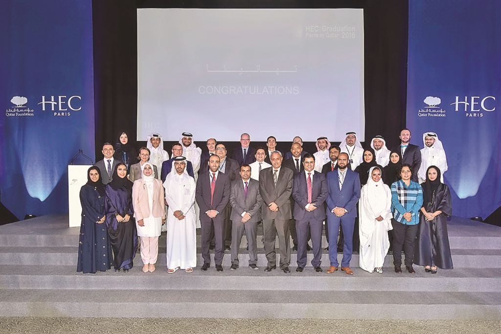 Officials with the graduates at the ceremony.