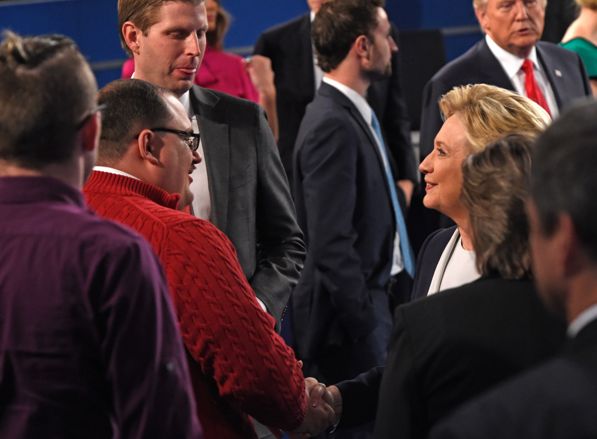 In this file photo dated October 9, 2016 US Democratic Presidential nominee Hillary Clinton (R) shakes hands with Ken Bone following the second presidential debate with Republican nominee Donald Trump (far R background) at Washington University in St. Lou
