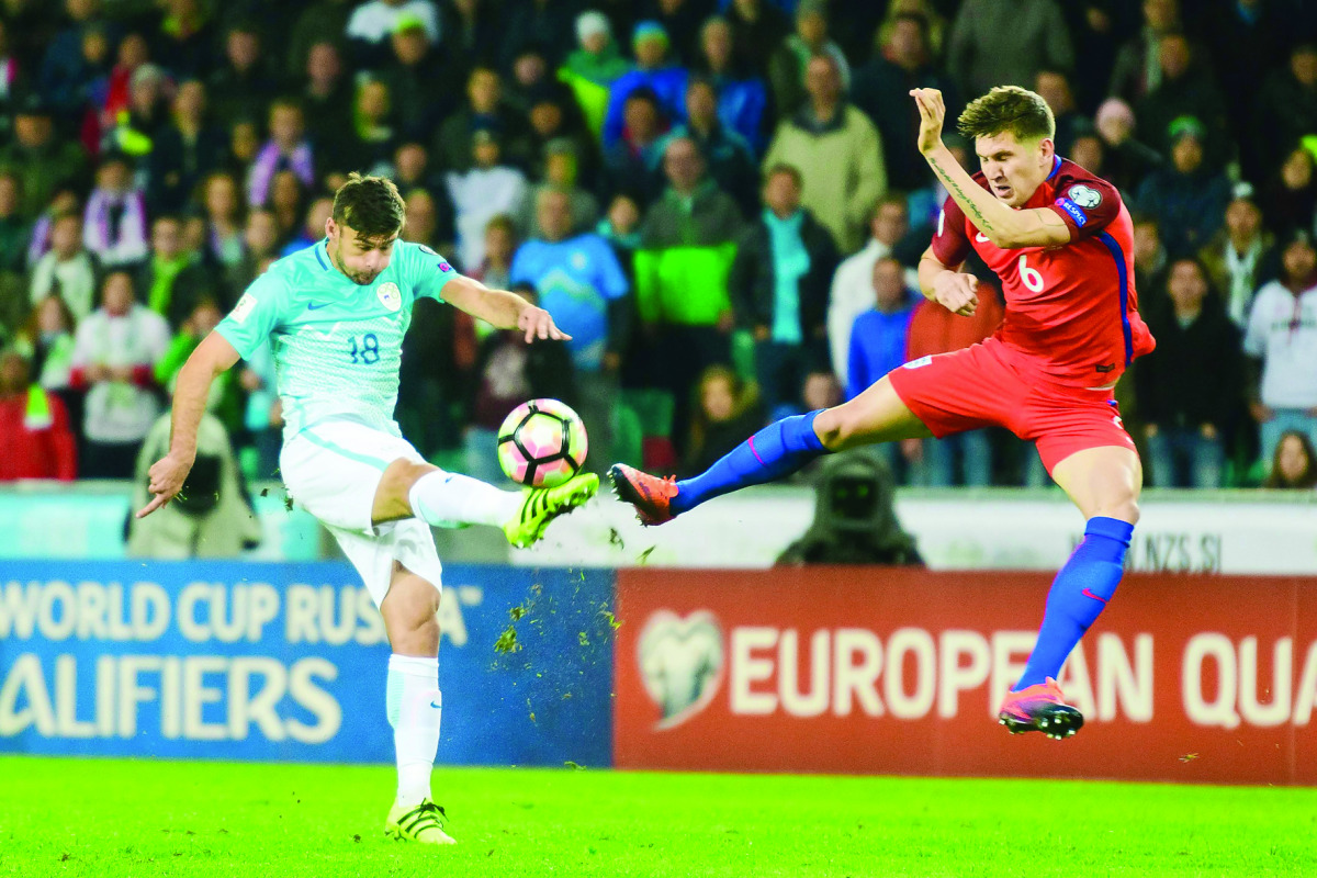 Slovenia’s Rok Kronaveter (left) vies for the ball with England’s John Stones during their 2018 World Cup qualifying match at Stozice Stadium in Ljubljana, Slovenia on Tuesday.