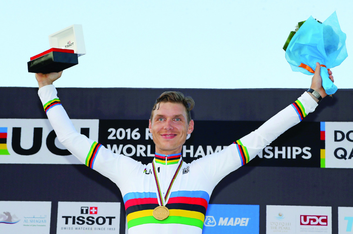 Germany’s Tony Martin celebrates on the podium after winning the gold medal at the end of the men’s elite individual time trial event in Doha