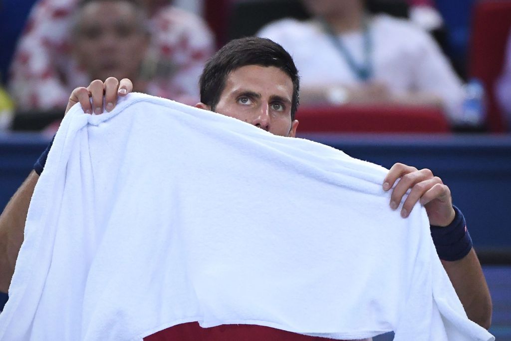 Novak Djokovic of Serbia looks on during a break in the men's singles semifinals match against Roberto Bautista Agut of Spain at the Shanghai Masters tennis tournament in Shanghai on October 15, 2016. / AFP / WANG ZHAO