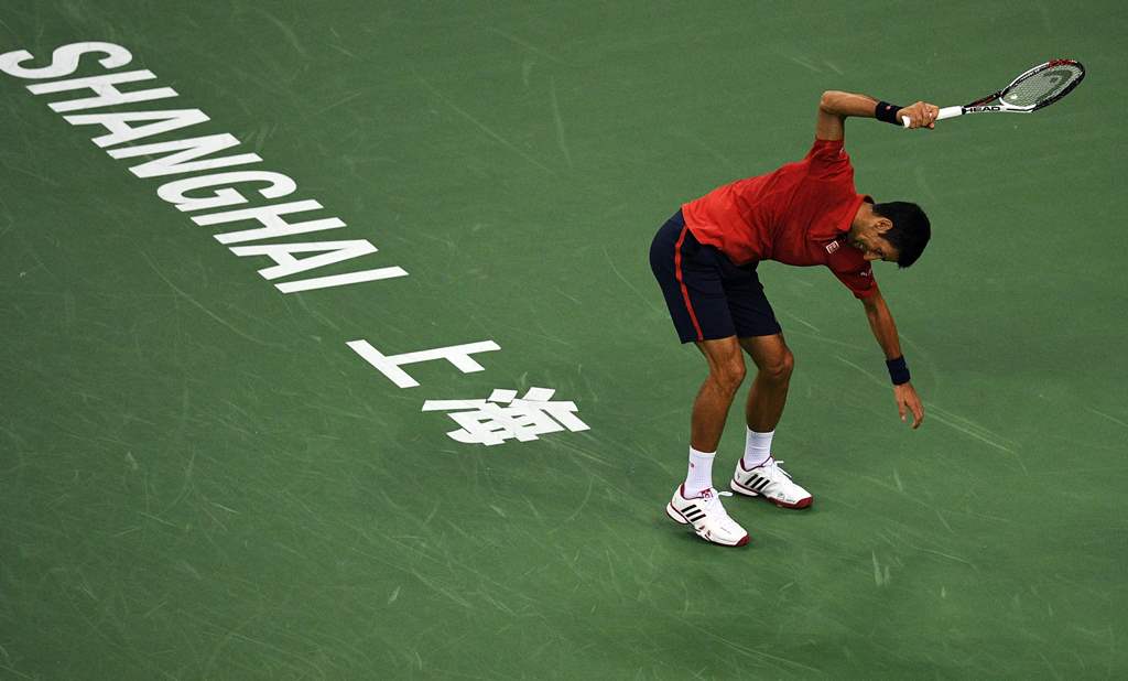 This file photo taken on October 15, 2016 shows Novak Djokovic of Serbia smashing his racket after losing a point against Roberto Bautista Agut of Spain in their men's singles semi-finals match at the Shanghai Masters tennis tournament in Shanghai. AFP / 