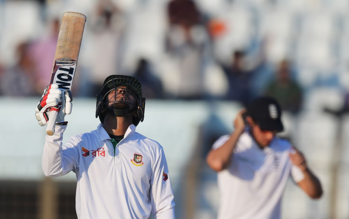 Bangladesh Sabbir Rahman celebrates a half-century (50 runs) as England's captain Alastair Cook looks on during the fourth day's play of the first Test cricket match between Bangladesh and England at Zahur Ahmed Chowdhury Cricket Stadium in Chittagong on 