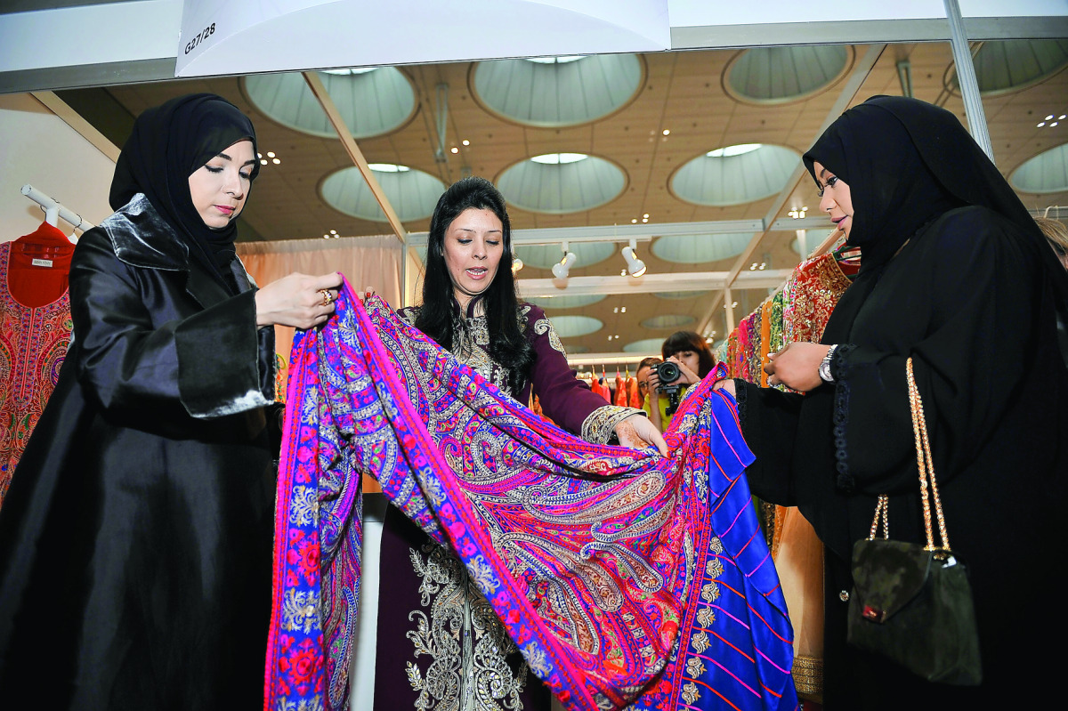 Ibteihaj Al Ahmadani, Head of Health Committee at Qatar Chamber, and Qomasha Al Jabor, Head of Exhibition Technical Support Section at QTA, during the grand opening of Heya Arabian Fashion Exhibition which took place at DECC on Thursday. Below: Creations 