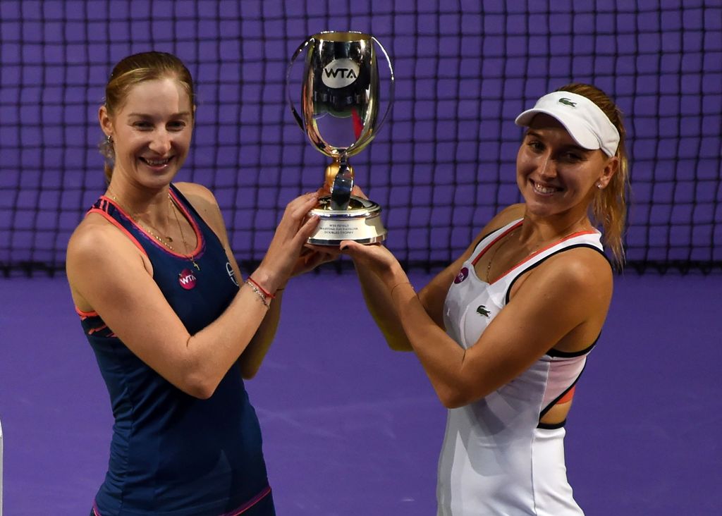 Ekaterina Makarova (L) and Elena Vesnina of Russia (R) pose with the trophy after their victory in the women's doubles final against Bethanie Mattek-Sands of the US and Lucie Safarova of the Czech Republic at the WTA Finals tennis tournament in Singapore 