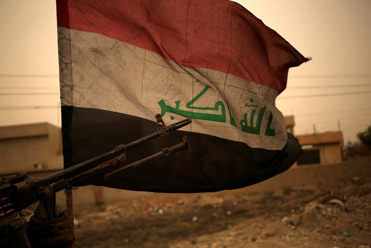 Iraq's flag is seen during a sand storm in Bartilla, east of Mosul, Iraq November 1, 2016. (REUTERS/Zohra Bensemra) 