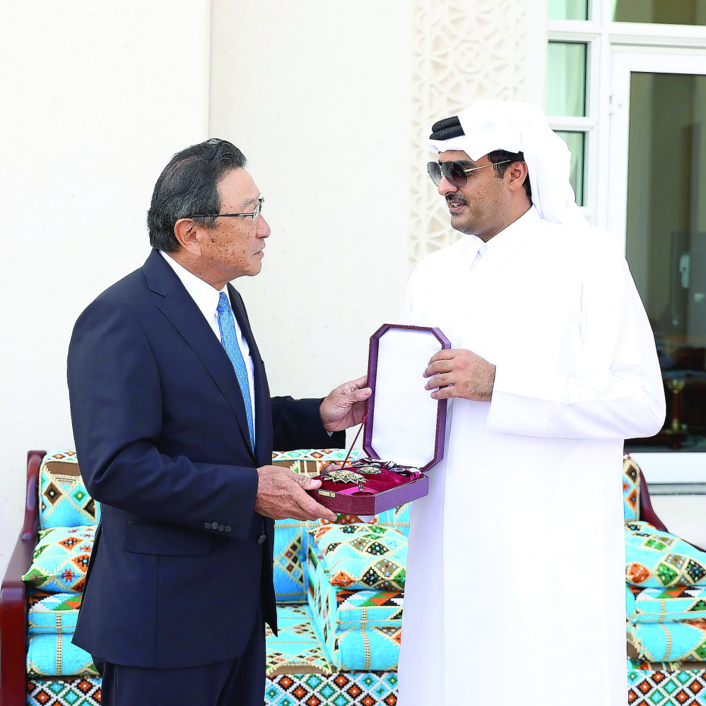 Emir H H Sheikh Tamim bin Hamad Al Thani presenting the outgoing Japan's Ambassador Shingo Tsuda with the Sash of Merit, at Emiri Diwan yesterday.