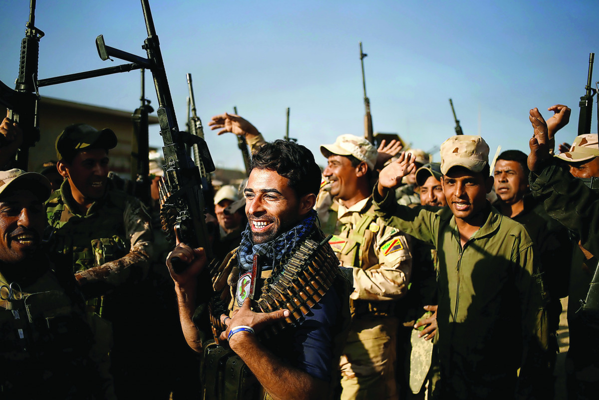 Iraqi soldiers celebrate during a fighting with Islamic State militants, at the front line in the Shahrazad district of eastern Mosul, yesterday.