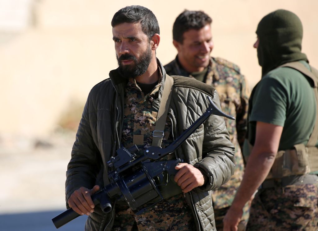A member of the Syrian Democratic Forces (SDF) holds a grenade-launcher as he gathers with comrades in the town of Ain Issa, some 50 kilometres north of Raqa, on November 6, 2016. The US-backed alliance of Kurdish and Arab fighters launched on November 6 
