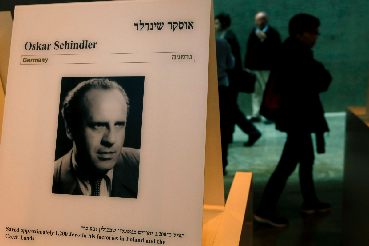  This file photo taken on March 04, 2015 shows visitors walking past a portrait of the German industrialist who saved more than a thousand Jews, Oskar Schindler at the Yad Vashem Holocaust memorial museum in Jerusalem. A former factory of Oskar Schindler 
