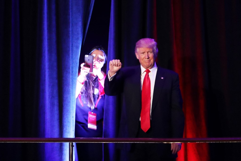 Republican president-elect Donald Trump acknowledges the crowd during his election night event at the New York Hilton Midtown in the early morning hours of November 9, 2016 in New York City. Spencer Platt/Getty Images/AFP