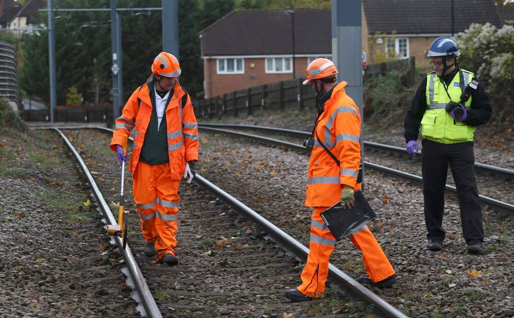 Crash investigators work on the tracks near the site of an accident where a tram overturned killing 7 people and injuring 50 passengers in Croydon, south London, Britain November 10, 2016. REUTERS/Neil Hall
