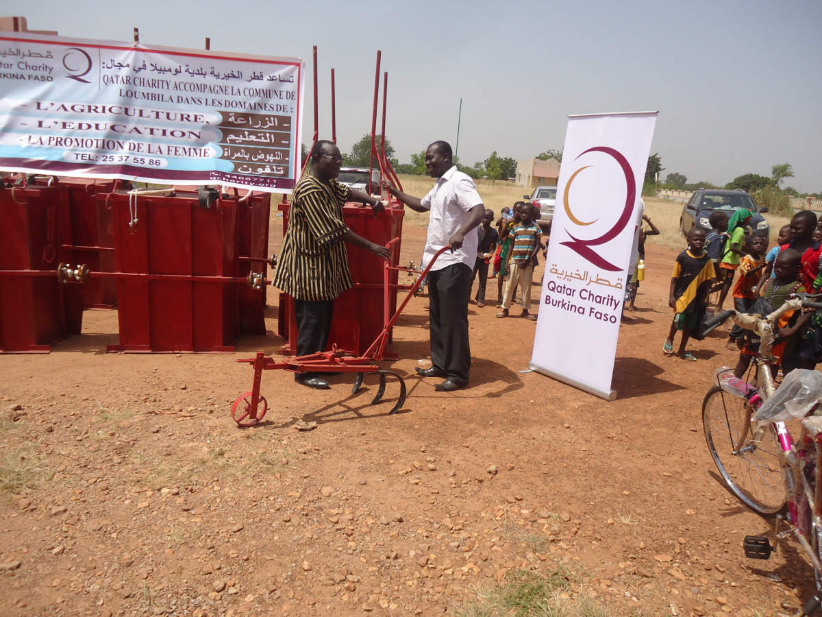 A farmer receiving agricultural equipment under an empowerment scheme run by Qatar Charity in Burkina Faso.