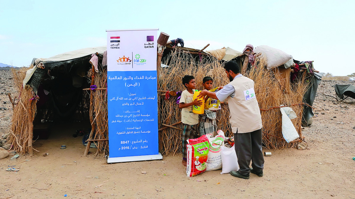 Two children receiving education and food supplies provided by RAF in Yemen.