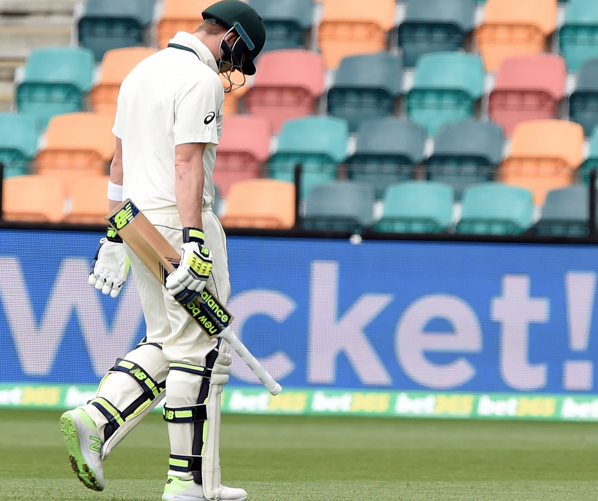 Australia's captain Steven Smith walks off the field with his heads down following his dismissal off South Africa's paceman Kagiso Rabada on the fourth day's play of the second Test cricket match between Australia and South Africa in Hobart on November 15