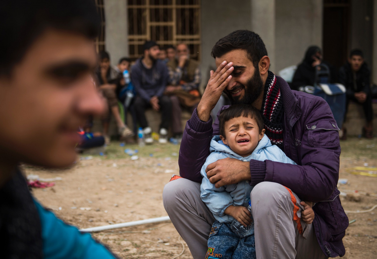  Iraqis fleeing the fighting rest as they reach an area held by Iraqi Special Forces 2nd division for transport out of the combat zone in the Samah neighbourhood of Mosul on November 15, 2016. Hundreds of people used the opportunity to try and get out of 