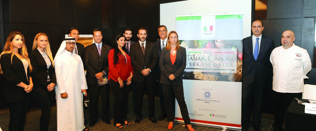 Guido De Sanctis, Italian Ambassador to Qatar; Palma Libotte, Chairperson of the Italian Chamber; and other officials at the press conference.