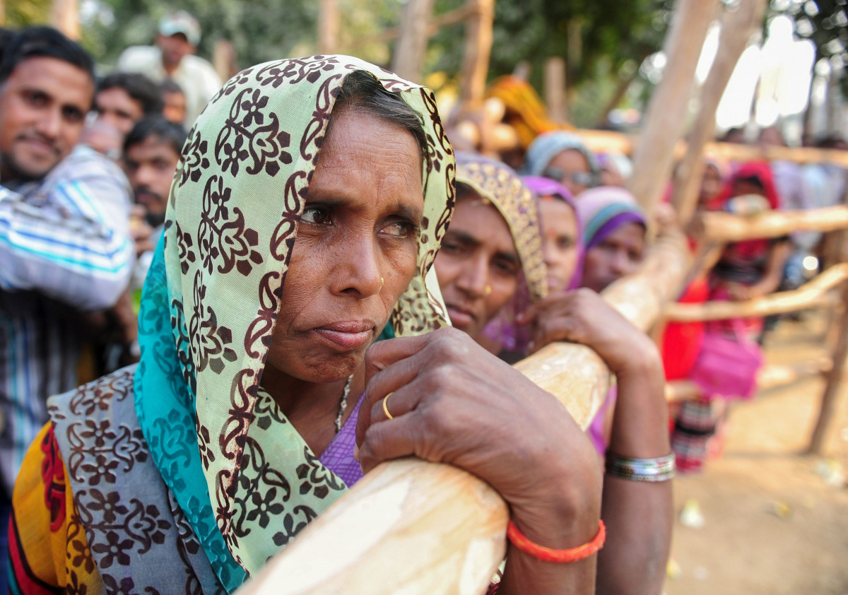Indian villagers queue outside a bank as they wait to deposit and exchange 500 and 1000 rupee notes in Hanuman Ganj village on the outskirts of Allahabad on November 18, 2016. India's government asked its citizens to put up with what it called the 