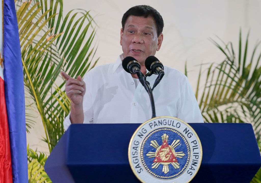 Philippine President Rodrigo Duterte gestures as he delivers a speech, prior to his departure for the APEC summit in Peru, at Davo airport, in southern island of Mindanao on November 17, 2016. AFP / MANMAN DEJETO