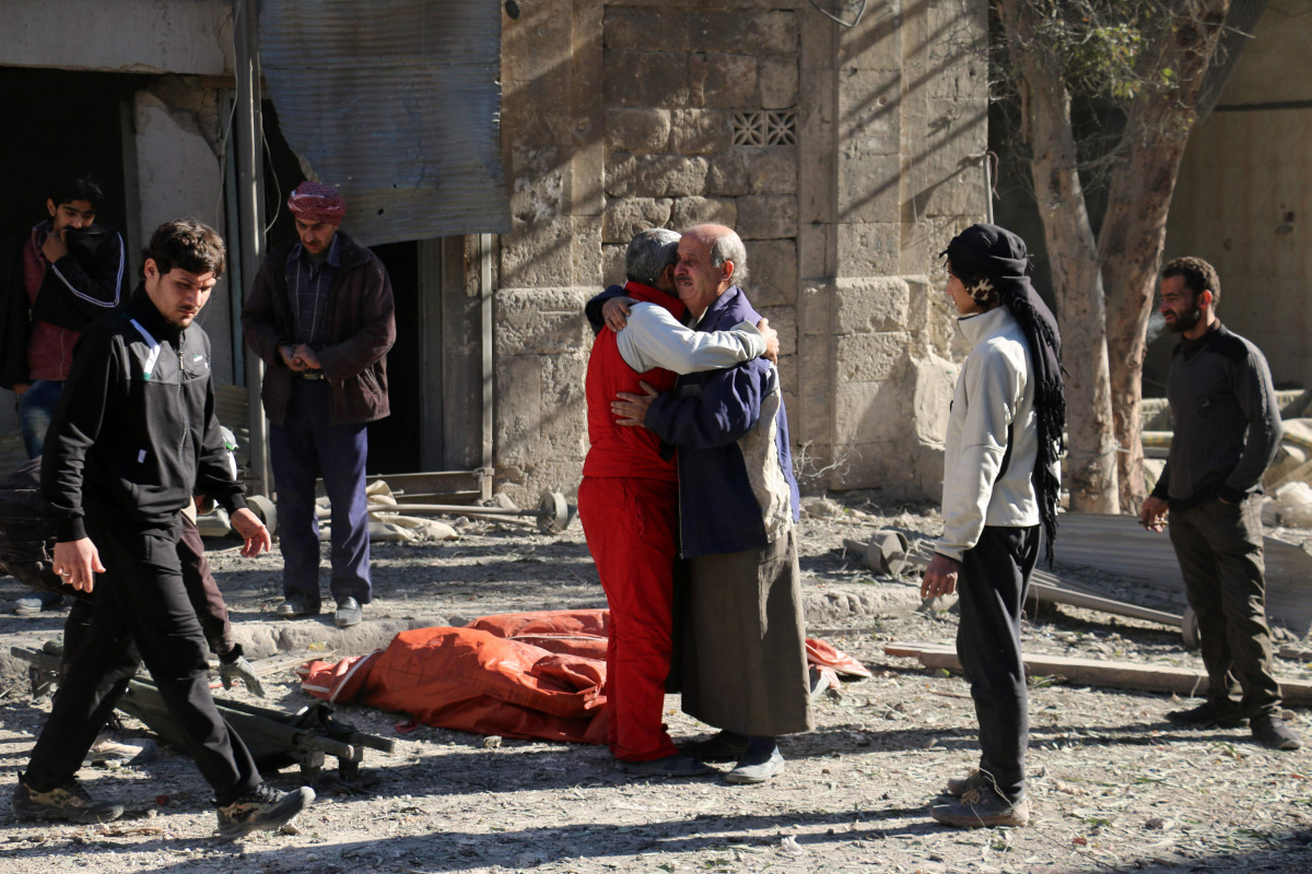 Syrians comfort each other on November 19, 2016 following a reported air strike on Aleppo's rebel-held neighbourhood of Bab al-Nayrab. Intense government air strikes and artillery fire killed at least 27 people in rebel-held parts of Syria's Aleppo, where