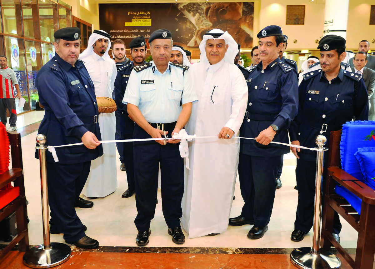 Brig Gen Mohamed Saad Al Kharji, Director-General Traffic Directorate, cutting the ribbon with Gen, Mohamed Al-Malki (centre) Secretary-General of NTSC, at the opening of the World Day of Remembrance of Road Traffic Victims exhibition at the headquarters 