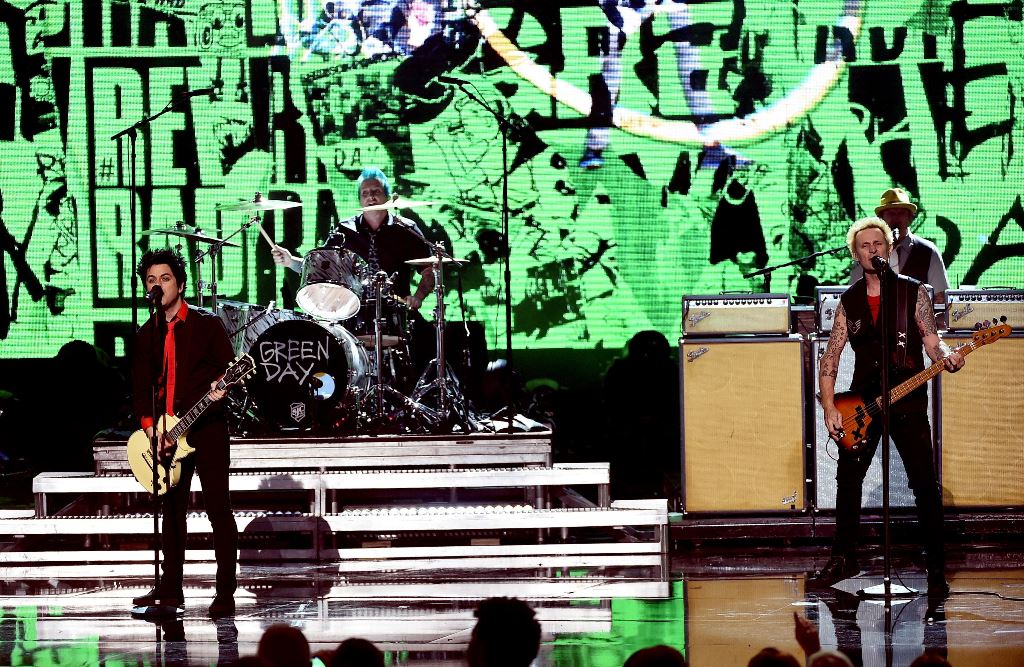 (L-R) Musicians Billie Joe Armstrong, Tre Cool and Mike Dirnt of Green Day perform onstage during the 2016 American Music Awards at Microsoft Theater on November 20, 2016 in Los Angeles, California. Kevin Winter/Getty Images/AFP