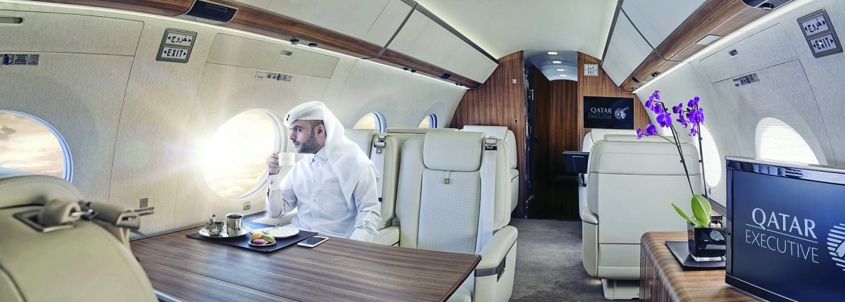 A guest of Qatar Executive enjoying a sip of coffee inside the Gulfstream G650ER’s cabin  equippped with the most advanced technology, including satellite communications.
